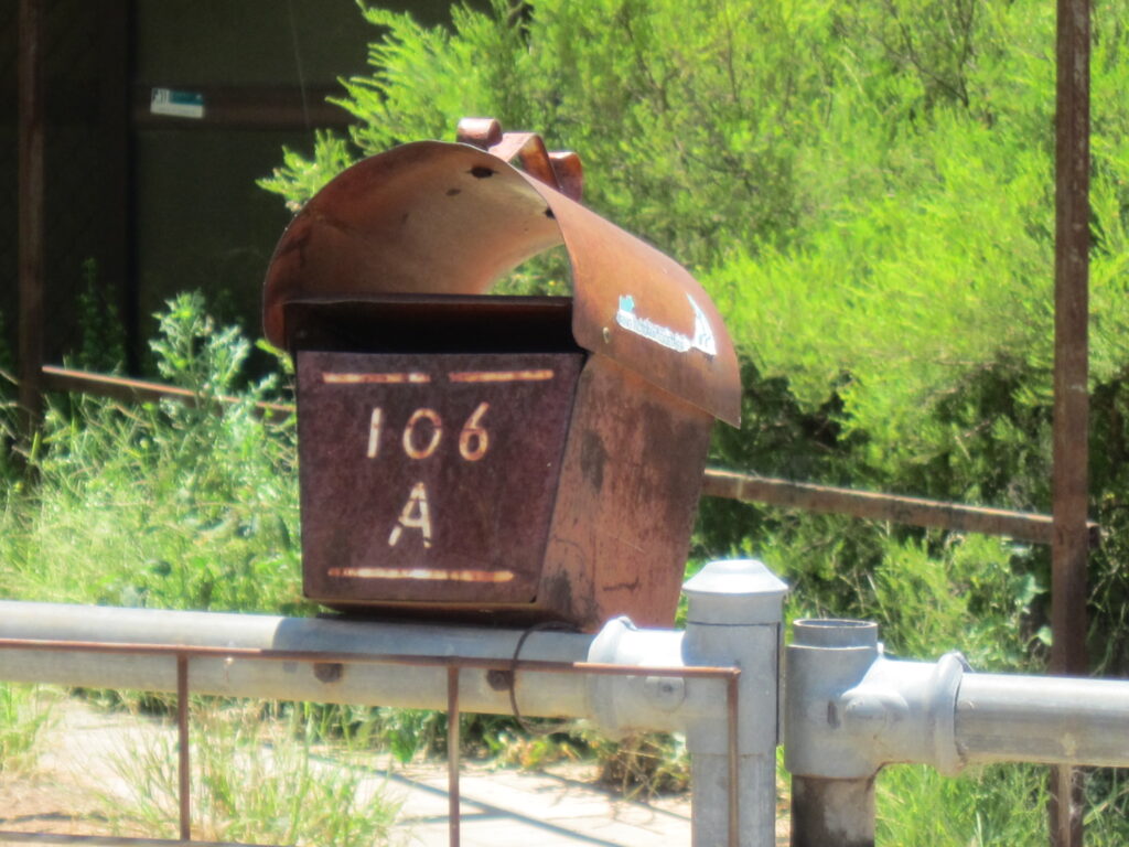 Old rusty letterbox with number 106A